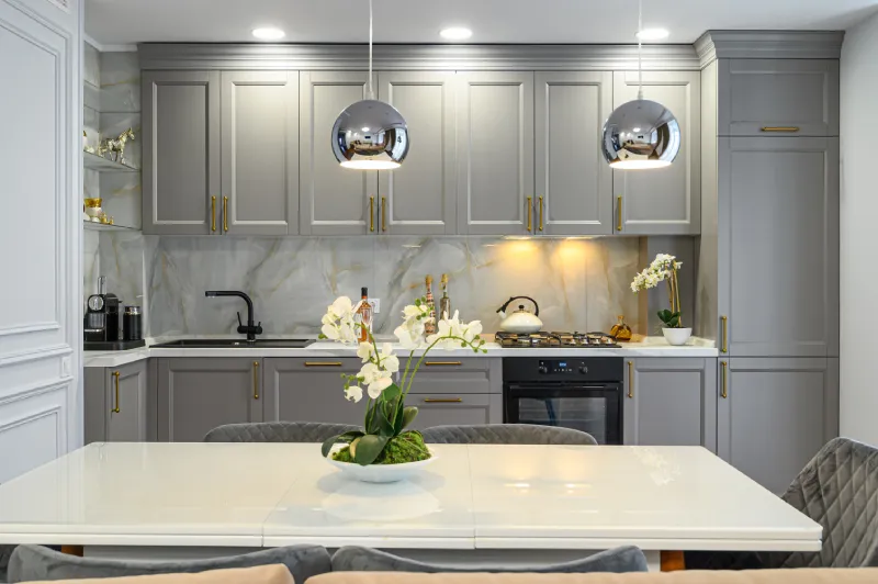 Illuminated grey and white luxury kitchen in modern style