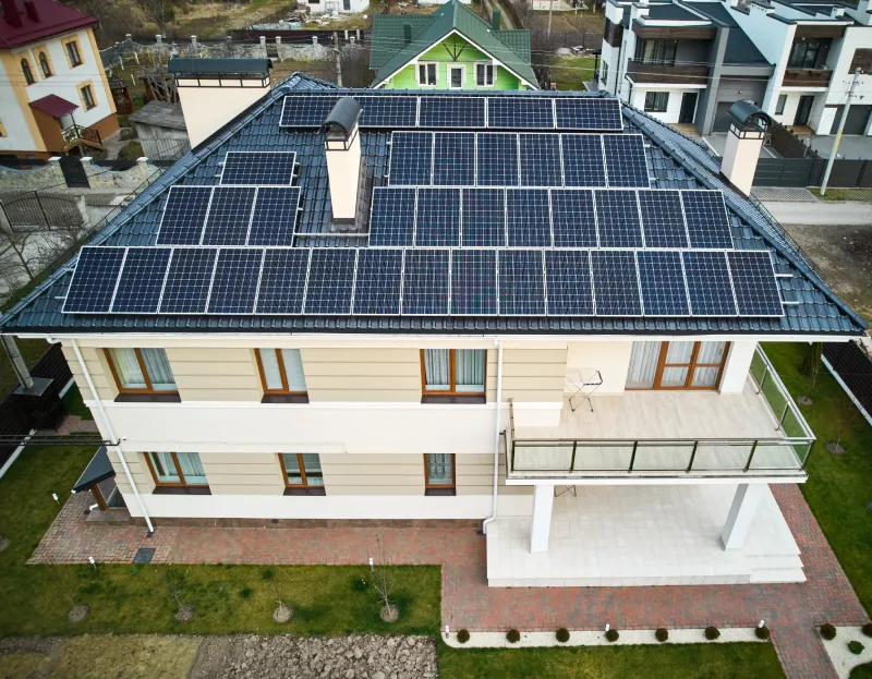 Residential house with solar panel modules on rooftop